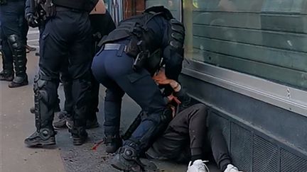 Capture écran de la vidéo du policier qui frappe un manifestant au sol à Paris le 18 janvier.&nbsp; (- / HANDOUT)