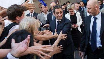 Nicolas Sarkozy sort du si&egrave;ge de l'UMP, le 8 juillet 2013. (REVELLI-BEAUMONT / SIPA)