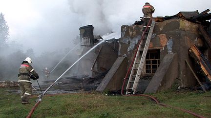 Des pompiers &eacute;teignent l'incendie d'un h&ocirc;pital psychiatrique, &agrave; Louka, en Russie, le 13 septembre 2013. (AFP)