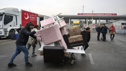 Des réfugiés syriens en Turquie poussent leurs affaires en direction de la Syrie, le 12 décembre 2024. (YASIN AKGUL / AFP)