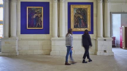 Deux tableaux de "La Vierge à l'Enfant avec le jeune saint Jean-Baptiste", une version récemment authentifiée comme œuvre originale du XVIe siècle (G) aux côtés de son modèle, réalisé par Sandro Botticelli, prêté par la galerie des Offices, sont exposés dans la chapelle du château de Chambord, à Chambord, le 10 octobre 2024. (GUILLAUME SOUVANT / AFP)