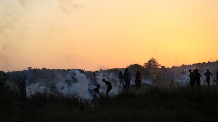 Des Palestiniens affrontent des soldats isra&eacute;liens tirant des gaz lacrymog&egrave;nes, le 15 octobre 2015 dans la bande de Gaza. (MOHAMMED ABED / AFP)