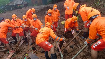 Rescuers search for victims at the site of a landslide in Raigad district in Maharashtra state on July 22, 2023, India.  (INDIA'S NATIONAL DISASTER RESPONSE / AFP)