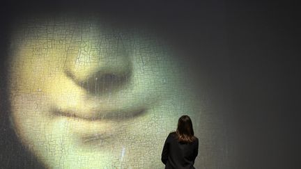 Une visiteuse de l'exposition "La Joconde, une exposition immersive" au Palais de la Bourse de Marseille le 8 mars 2022. (NICOLAS TUCAT / AFP)