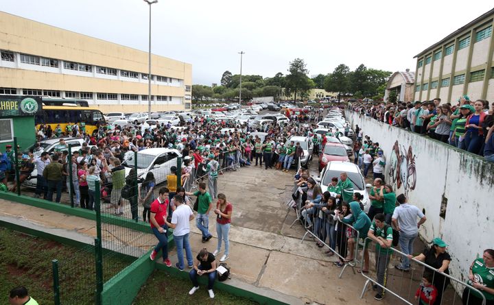 Des supporters de Chapecoense réunis devant l'Arena Conda, le 29 novembre 2016, à Chapeco (Brésil). (PAULO WHITAKER / REUTERS)