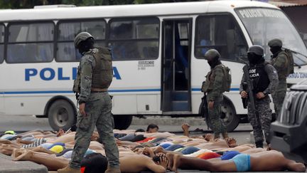 Police monitor arrested men who tried to take over a hospital in Guayas, Ecuador, January 21, 2024. (STRINGER / AFP)