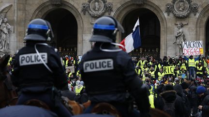 Des policiers montés font face à des "gilets jaunes" lors d'une manifestation à Paris, le 15 décembre 2018. (GEOFFROY VAN DER HASSELT / AFP)