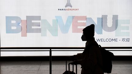 Un passager quitte un terminal après avoir atterri à l'aéroport&nbsp;de Paris-Charles-de-Gaulle (Roissy), le 26 janvier 2020. (ALAIN JOCARD / AFP)