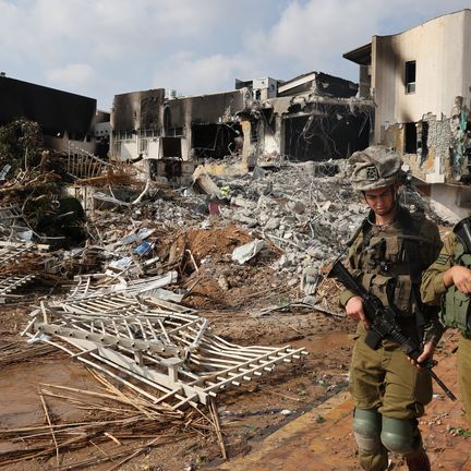 Des soldats israéliens devant un commissariat détruit lors d'affrontements avec des terroristes du Hamas, le 8 octobre 2023 à Sderot, à quelques kilomètres de la frontière avec la bande de Gaza. (JACK GUEZ / AFP)