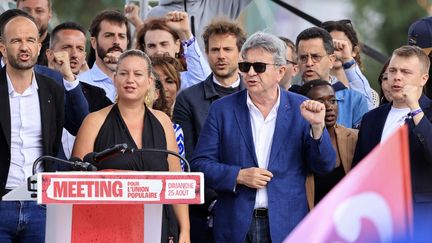 Manuel Bompard, Mathilde Panot, Jean Luc Mélenchon and Louis Boyard sing at the end of a meeting of the summer days of La France insoumise, on August 25, 2024, in Châteauneuf-sur-Isère (Drôme). (LAETITIA NOTARIANNI / HANS LUCAS / AFP)