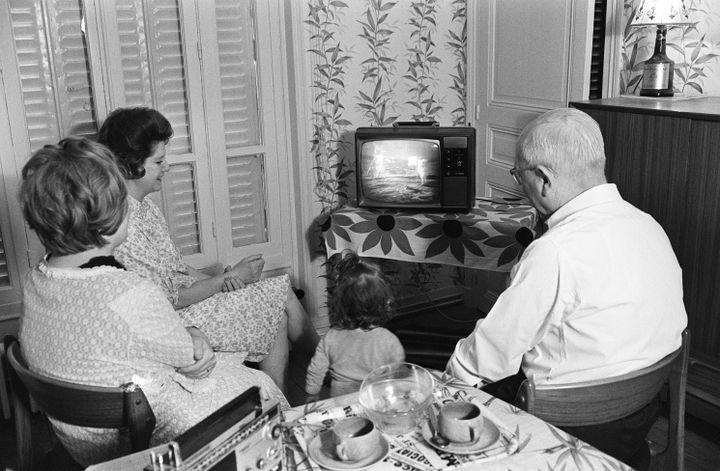 Une famille&nbsp;devant sa télévision, le 21 juillet 1969, pour regarder les premiers pas de l'homme sur la Lune. (AFP)