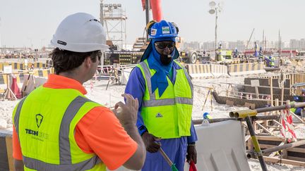 Une photo, diffusée le 30 août 2018 par les organisateurs du Mondial de foot 2022, montre un ouvrier portant un "gilet de refroidissement" sur un chantier à Doha&nbsp;(Qatar). (MOHAMED YOUSUF DABBOUS / QATAR WORLD CUP ORGANISERS / AFP PHOTO)