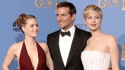 Amy Adams, Bradley Cooper et Jennifer Lawrence, acteurs de "American Bluff" de David O. Russell, trois fois récompensé aux 71 Golden Globes (12 janvier 2014)
 (Kevin Winter / Getty Images North America / AFP)