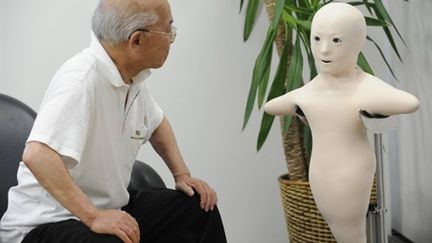 Un grand-père communique avec sa petite fille via ce prototype de Telenoïd R1 à Osaka - 01/08/10 (AFP Yoshikazu Tsuno)