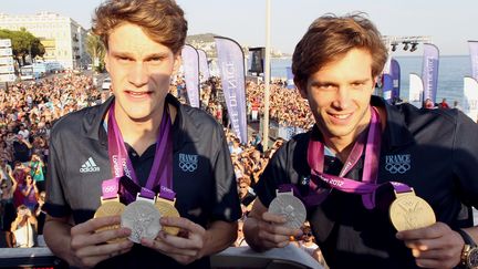 Le nageur Cl&eacute;ment Lefert&nbsp;(&agrave; droite) aux c&ocirc;t&eacute;s de Yannick Agnel, lors d'un d&eacute;fil&eacute; organis&eacute; par la mairie de Nice pour f&ecirc;ter les m&eacute;daill&eacute;s aux Jeux olympiques de Londres, le 10 ao&ucirc;t 2012. (VALERY HACHE / AFP)