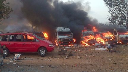 Des voitures br&ucirc;lent apr&egrave;s l'attentat qui a frapp&eacute; les environs d'Abuja (Nigeria), le 14 avril 2014, quelques heures avant que des islamistes de Boko Haram enl&egrave;vent plus de 100 lyc&eacute;ennes. ( AFP )