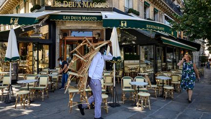 Les employés de la brasserie Les&nbsp;Deux Magots préparent la terrasse pour la réouverture, le 1er juin 2020 à Paris. (BERTRAND GUAY / AFP)