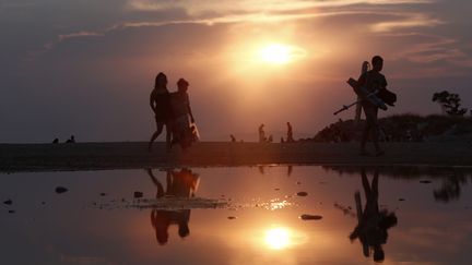 Des personnes quittent la plage de Glyfada (Gr&egrave;ce), le 25 ao&ucirc;t 2013. (JOHN KOLESIDIS / REUTERS)