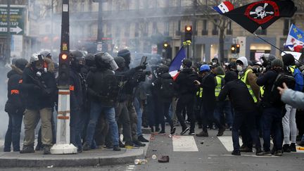 Des membres des forces de l'ordre face à des "gilets jaunes", à Paris, le 2 février 2019. (FRANCOIS GUILLOT / AFP)