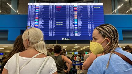 Tourists at the airport on the Greek island of Rhodes as evacuations are underway due to forest fires, July 23, 2023. Illustrative photo.  (WILL VASSILOPOULOS / AFP)