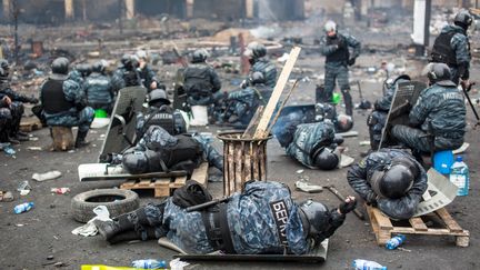 Tous les bellig&eacute;rants sont &eacute;puis&eacute;s, comme le montre cette photo de policiers ukrainiens qui se reposent sur le Ma&iuml;dan. (ANDREY STENIN / RIA NOVOSTI / AFP)