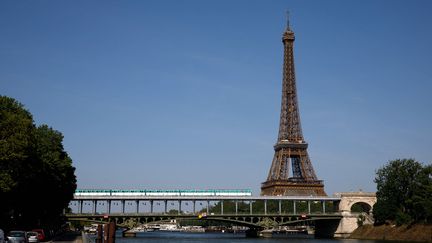 La tour Eiffel, à Paris, photographiée le 2 juin 2023 depuis les berges de la Seine dans le 16e arrondissement. (GILLES TARGAT / AFP)