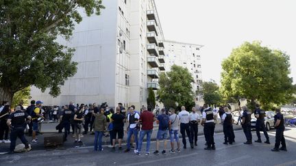 Policiers et habitants du quartier dans la Cité des Flamants, dans le 14e arrondissement de Marseille (Bouches-du-Rhône) le 17 juillet 2021, après l'incendie qui a fait trois morts et plusieurs blessés (FRANCK PENNANT / MAXPPP)