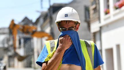 Un ouvrier s'essuie le visage lors d'une journée de forte chaleur, à&nbsp;Brive-la-Gaillarde (Corrèze), le 14 juin 2022. (MAXPPP)