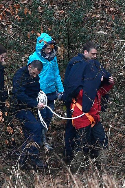 Hubert Caouissin et son avocat, lors d'une première reconstitution des meurtres de la famille Troadec, le 12 mars 2019, à&nbsp;Pont-de-Buis (Finistère). (FRED TANNEAU / AFP)