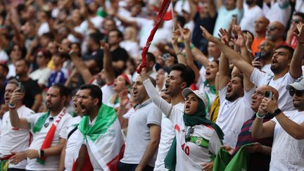 Des supporteurs et supportrices iraniens lors du match Iran-pays de Galles lors de la Coupe du monde de football à Doha (Qatar), le 25 novembre 2022. (ADRIAN DENNIS / AFP)