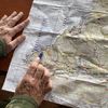 Un soldat de la Force intérimaire des Nations unies au Liban (Finul) déploie une carte du sud du Liban, le 13 janvier 2024, sur la base de Naqoura. (RAPHAEL GODET / FRANCEINFO)