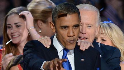 "Notre pays va de l'avant, gr&acirc;ce &agrave; vous", a clam&eacute; Obama avant d'&ecirc;tre rejoint par ses proches dont le vice-pr&eacute;sident Joe Biden et d'&ecirc;tre recouvert d'une pluie de confettis bleus rouges et blancs. (SAUL LOEB / AFP)