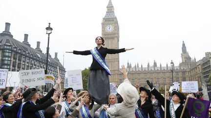 Des f&eacute;ministes d&eacute;guis&eacute;es en suffragettes manifestent pour demander l'&eacute;galit&eacute;, &agrave; Londres, le 24 octobre 2012.&nbsp; (ANDREW WINNING / REUTERS )