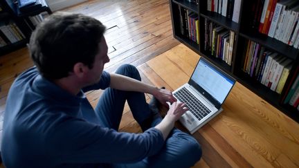 Un homme en télétravail à son domicile. Photo d'illustration. (REMY PERRIN / MAXPPP)