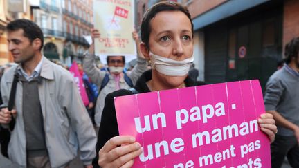 Pendant ce temps, &agrave; Toulouse toujours, les opposants brandissaient des pancartes portant les slogans martel&eacute;s depuis plusieurs mois. (ERIC CABANIS / AFP)