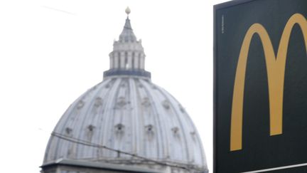 Un panneau indique la direction du McDonald's, non loin de la coupole de la basilique Saint-Pierre de Rome, le 3 janvier 2017
 (Tiziana Fabi / AFP)