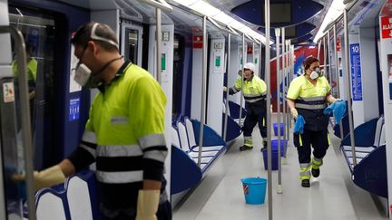 Des agents de nettoyage dans le métro de Madrid, la capitale espagnole, le 10 mars 2020. (HANDOUT / COMUNIDAD DE MADRID / AFP)