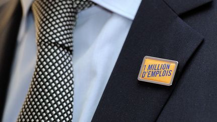 Un membre du Medef arbore un pin's "1 million d'emplois", lors d'une conf&eacute;rence de presse de l'organisation patronale &agrave; Marcq-en-Baroeul (Nord), le 13 janvier 2014. (PHILIPPE HUGUEN / AFP)