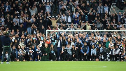 Les joueurs de Newcastle prennent la pose au St James' Park, le 22 mai 2023, après avoir assuré leur qualification en Ligue des champions. (LINDSEY PARNABY / AFP)