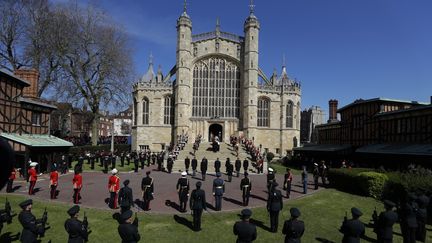 Le cercueil a ensuite été accueilli par les sifflements des pipes des marines, avant d'être porté dans la chapelle Saint-George, pour l'office religieux. Il était attendu en haut des marches par l'archevêque de Canterbury,&nbsp;Justin Welby,&nbsp;et le doyen de Windsor, David Conner. Un coup de canon a retenti pour annoncer une minute de silence dans tout le pays. (KIRSTY WIGGLESWORTH / AFP)