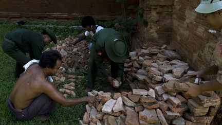 Les militaires et un officier de police ramasse les briques du temple de&nbsp;Dhammayangyi, le plus grand des temples bouddhistes de Bagan, construit au XIIe siècle.. (KYAW KYAW / ANADOLU AGENCY)