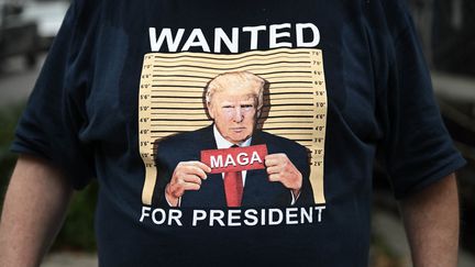 A man wears a t-shirt in support of former US President Donald Trump, during a protest on Staten Island, New York, August 2023. (FATIH AKTAS / ANADOLU AGENCY)