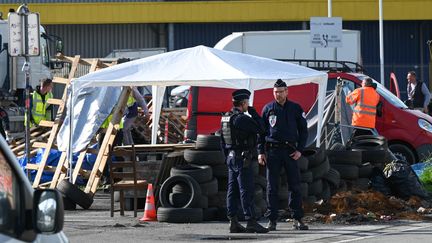 Des policiers encadrent le démantèlement d'un piquet de grève devant un entrepôt Vertbaudet à Marquette-lez-Lille (Nord), le 16 mai 2023. (DENIS CHARLET / AFP)