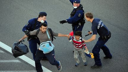 Le 7 septembre 2015, après avoir forcé un cordon policier près d'un centre d'accueil, un groupe de 200 migrants décide de rejoindre à pied Budapest en remontant à contresens sur la bande d'arrêt d'urgence une autoroute menant à la capitale hongroise. Mais après une quinzaine de kilomètres de marche,  la police les convainc de monter à bord d’un bus qui les amènera dans un autre centre d'accueil.  (AFP / CSABA SEGESVARI)