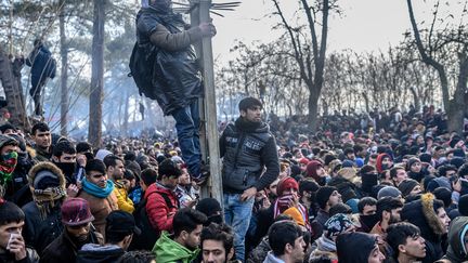 Plusieurs milliers de migrants se rassemblent dans la zone tampon de la frontière entre la Turquie et la Grèce, à Pazarkule&nbsp;(Turquie), le 29 février 2020. Ankara a provoqué une crise quelques jours plus tôt en&nbsp;assurant que la Turquie n'empêcherait plus les réfugiés de rejoindre l'Europe après la mort de 33 soldats turcs dans le nord de la Syrie. (BULENT KILIC / AFP)