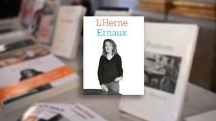 Cahier de L'Herne Annie Ernaux, sur fond des livres de la romancière, exposés à l'Académie Nobel le jour de l'annonce du Prix Nobel de littérature, le 6 octobre 2022 (JONATHAN NACKSTRAND / AFP)