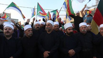 Druzes israéliens du village de Yarka brandissant le drapeau de leur communauté, le 14 juin 2015, en solidarité avec leurs 20 coreligionaires massacrés par des djihadistes dans la province d'Idlib au nord-ouest de la Syrie. (Jalaa Marey/AFP)