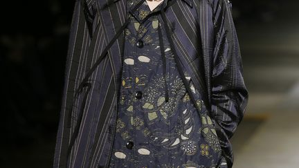 Dries Van Noten a fait défiler un bohémien à la silhouette empruntant à la fois à l'univers militaire, au punk et aux traditions de tribus chinoises, avec des superpositions, des vestes matelassées, des kilts, des broderies argentées. "On a surtout travaillé sur les décorations du vêtement, qui sont parfois militaires, parfois des protections, parfois aussi ethniques", explique à l'AFP le créateur belge après le show, où dominaient le noir, le marine et le bordeaux. "C'était intéressant de trouver les similitudes" entre ces vêtements, commente Dries Van Noten, qui s'est inspiré d'un livre du photographebritannique Jimmy Nelson, "Before They Pass Away" ("Avant qu'ils ne disparaissent") sur les peuples autochtones. La bande sonore, "Be my Baby", était une "chanson d'amour pour Paris", a commenté le designer.
 (PATRICK KOVARIK / AFP)