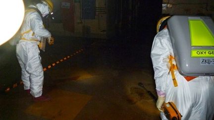 Des employés pénètrent dans l'enceinte du réacteur n°2 de la centrale de Fukushima, le 18 mai 2011. (AFP - Tepco)