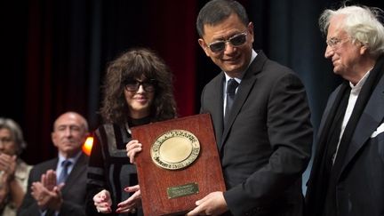 Le cinéaste chinois Wong Kar-wai reçoit le prix Lumière à Lyon, entouré d'Isabelle Adjani et de Bertrand Tavernier (octobre 2017)
 (ROMAIN LAFABREGUE / AFP)